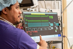 A VA medical health professional showing a Veteran his numbers 