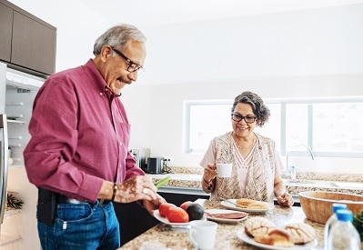 A Veteran and his wife making a healthy meal at home 