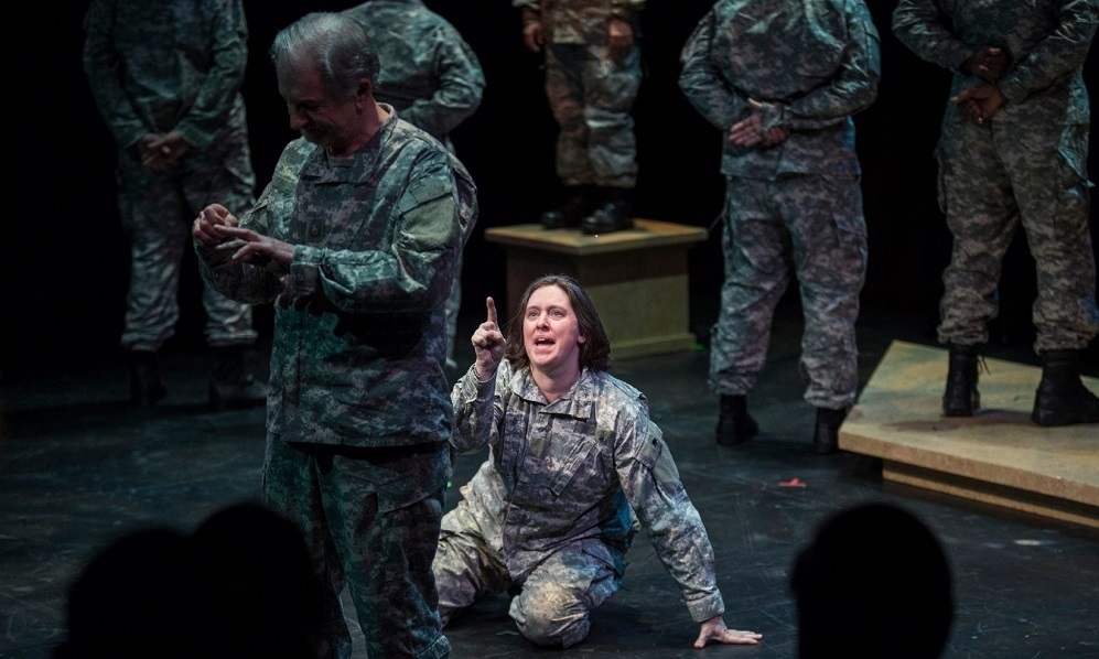 female in military uniform on the floor acting out a dramatic scene