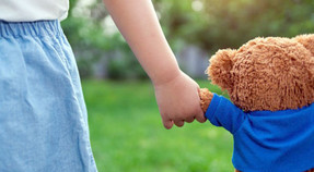 little girl holding teddy bear