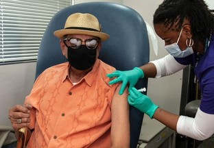 A man receives a vaccine