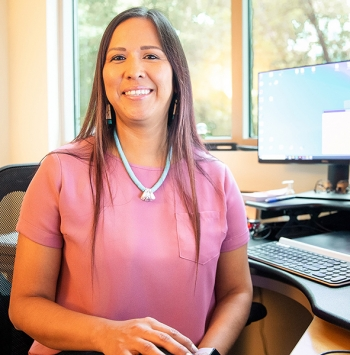 Native American health practitioner sitting at her desk