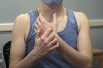 Acupuncturist demonstrates an acupressure point