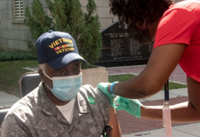 A Veteran receiving their flu shot outside of a VA facility 