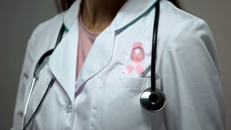 Pink ribbon on doctor's coat
