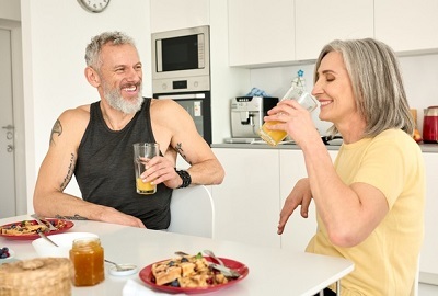 A Veteran and partner having a healthy meal after working out 