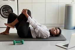 A Veteran learning back exercises from home