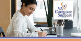 woman sitting at desk writing