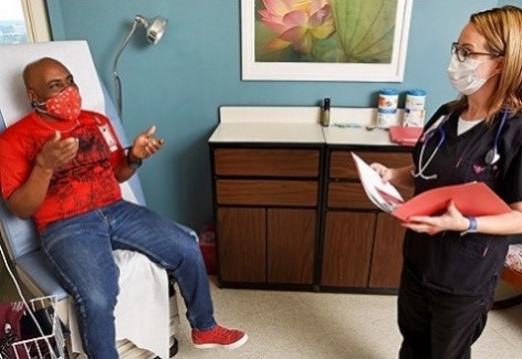 A man explains health concerns to a doctor