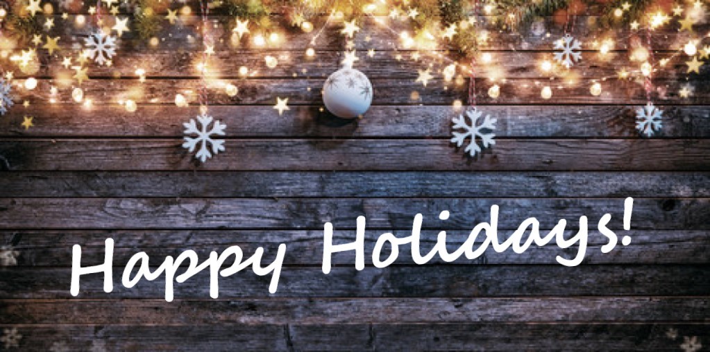 Barn wood with holiday bulbs and snowflakes inscribed with Happy Holidays