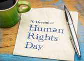 cup pen and napkin with human rights day Dec 10 written on it