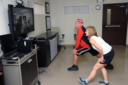 Two people in a virtual workout class 
