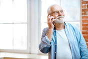 older man holding phone