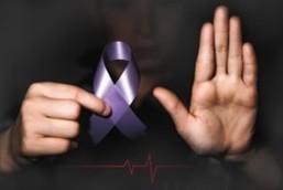 image of someone holding a purple ribbon