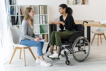 woman in wheelchair talking with a woman in a chair