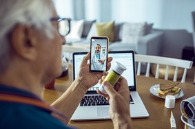A Veteran is using VA Video Connect to talk with his doctor about a VA prescription. 