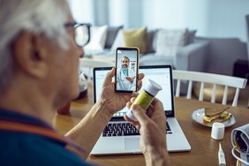 A Veteran is using VA Video Connect to talk with his doctor about a VA prescription. 