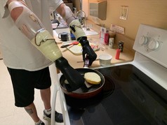 Veteran using prosthetic devices in kitchen