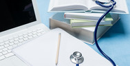 HPP-laptop-noteblook-pen-stethaclpe-and-books-short_crop