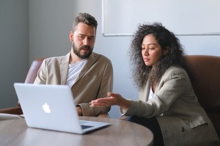 Therapist and client looking at computer together