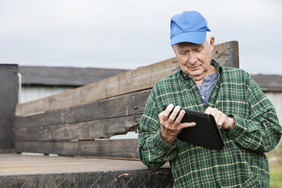 Rural Veteran reading his laptop
