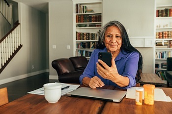 A Veteran refilling her prescriptions on her phone