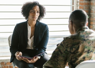 Therapist talking with service member
