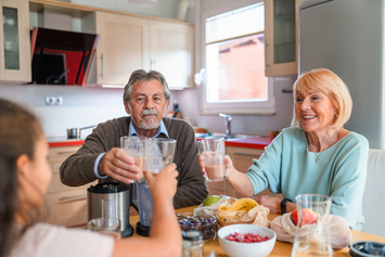 A Veteran and their family cheers with healthy smoothies.