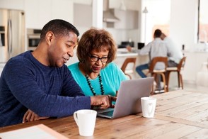 Man and woman look at information on computer