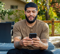 A Veteran using VA mobile apps on his phone