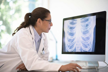 A VA doctor examining lung x-rays