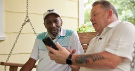 Man demonstrates iPhone to a Veteran