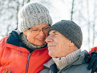 Elderly couple at a park in winter.