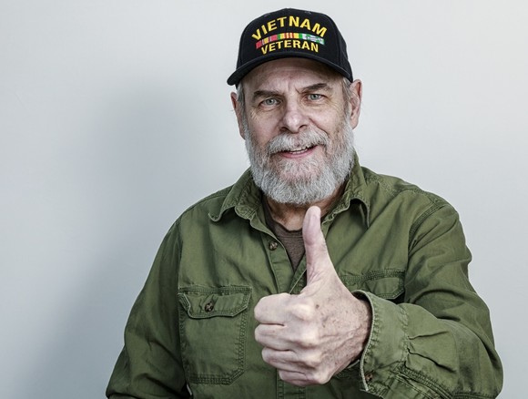 male Vietnam vet giving thumbs up sign