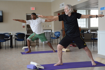 Veterans practicing standing balance exercises