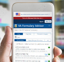 VA Formulary Advisor webpage shown on cell phone with pharmacy in background.