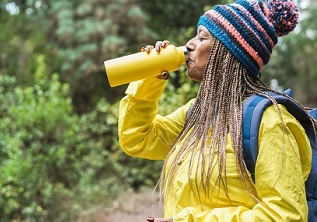 A Veteran drinking water on a hike