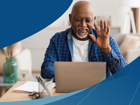 Veteran waving at computer