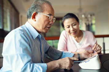 A Veteran and his wife monitoring his blood pressure at home