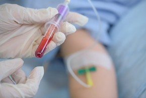 A medical clinician draws blood