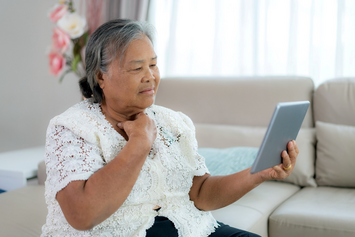 A Veteran consulting with her doctor via a telehealth appointment at home
