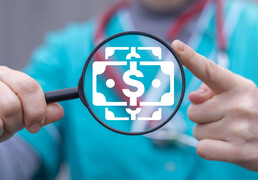Medical worker with magnifying glass showing dollar symbol.