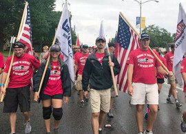 Carry the Load event with veterans marching