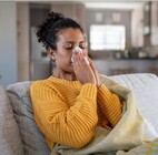 Woman blowing her nose