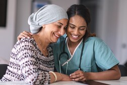 Women health care nurse and patient embrace