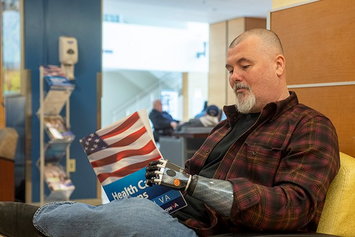 A Veteran reading a magazine in the prosthetic department waiting room