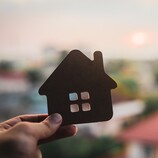 Person holding house cutout