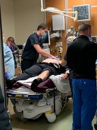 Emergency department staff assessing trauma wound