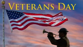 Veterans Day logo with a man in military uniform blowing a trumpet while US flag is flying above him