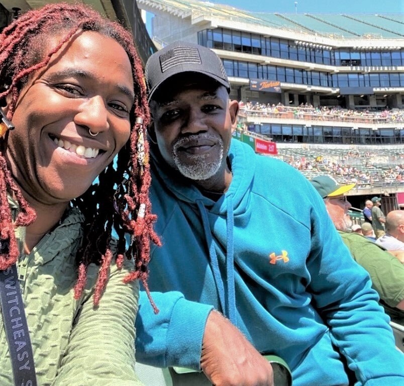 Recreational therapist and Veteran enjoy a baseball game